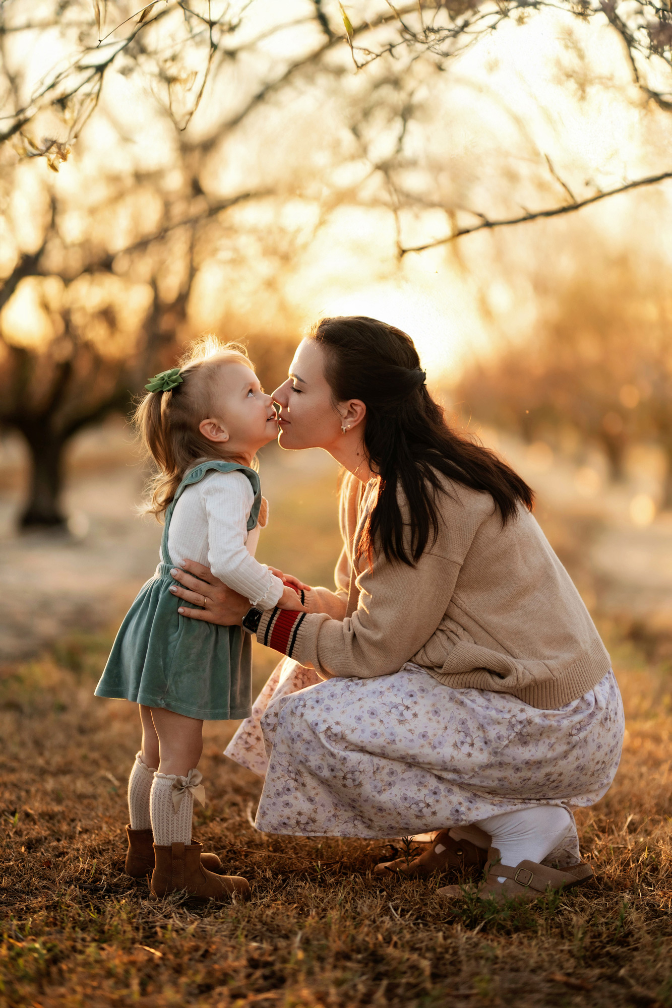 Mother kisses her daughter during lifestyle family photography session in Orlando