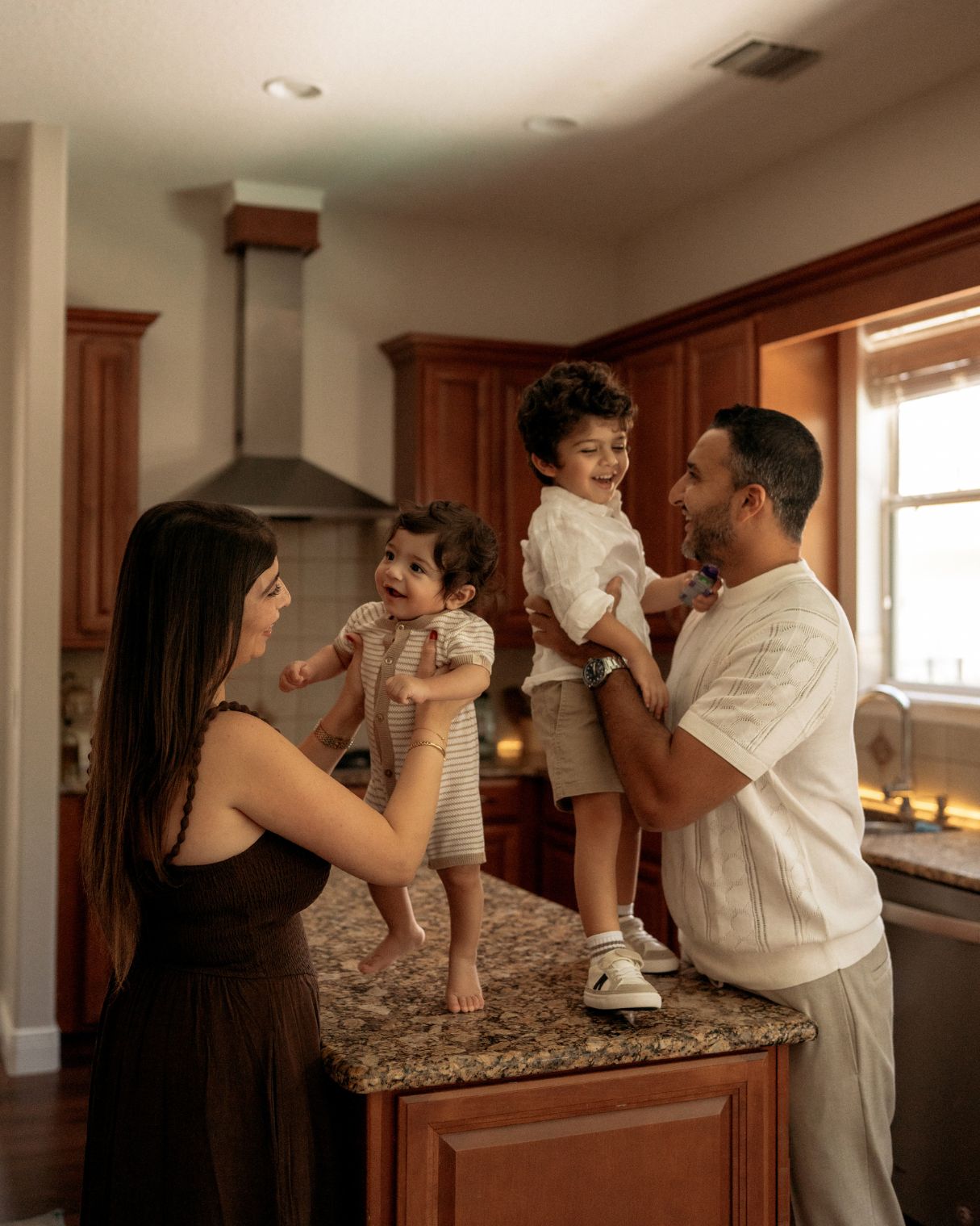 Parents sharing a natural moment with their children during a lifestyle family photoshoot in Orlando