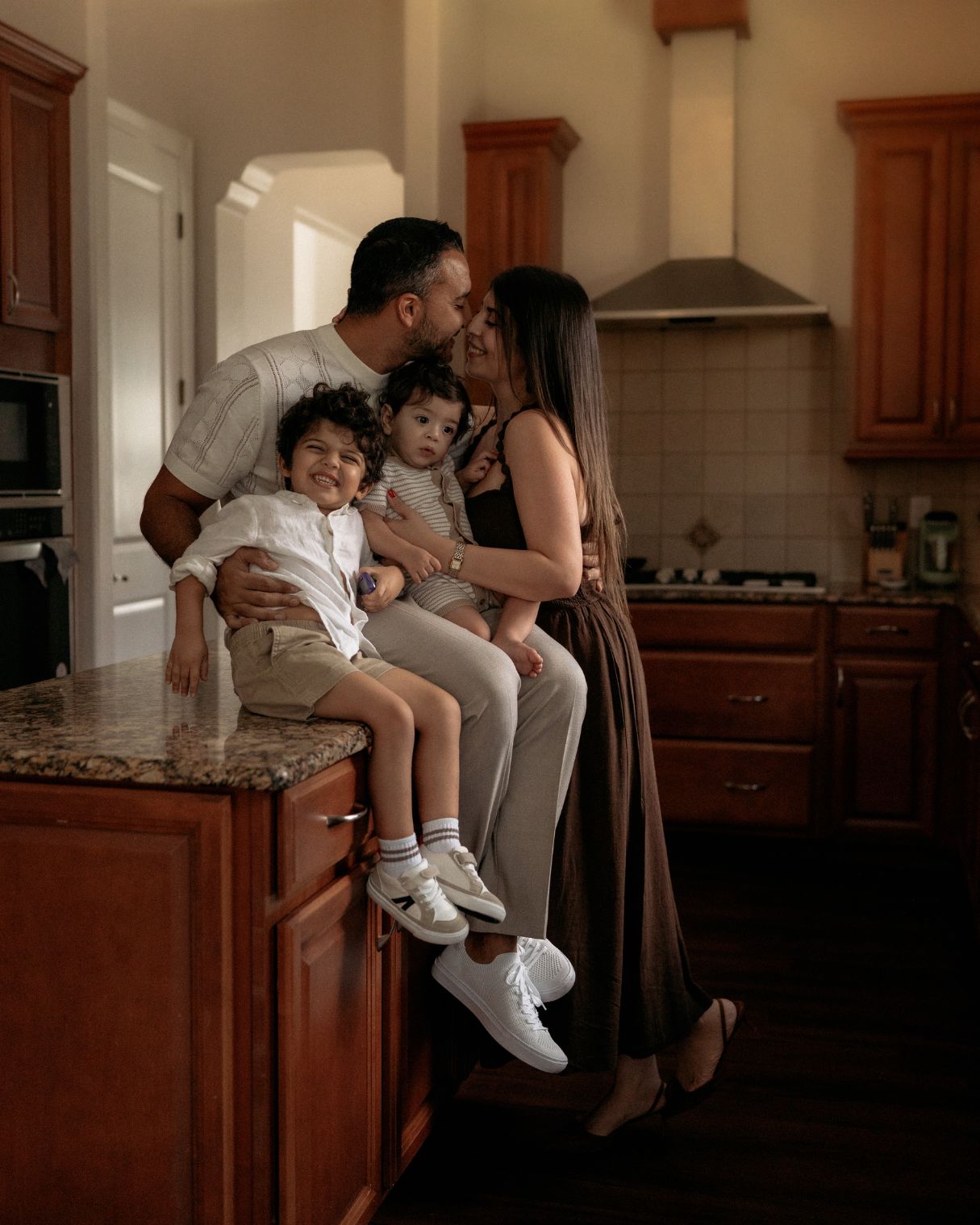 Family spending time together in their kitchen during an in-home family photography session in Orlando, Florida